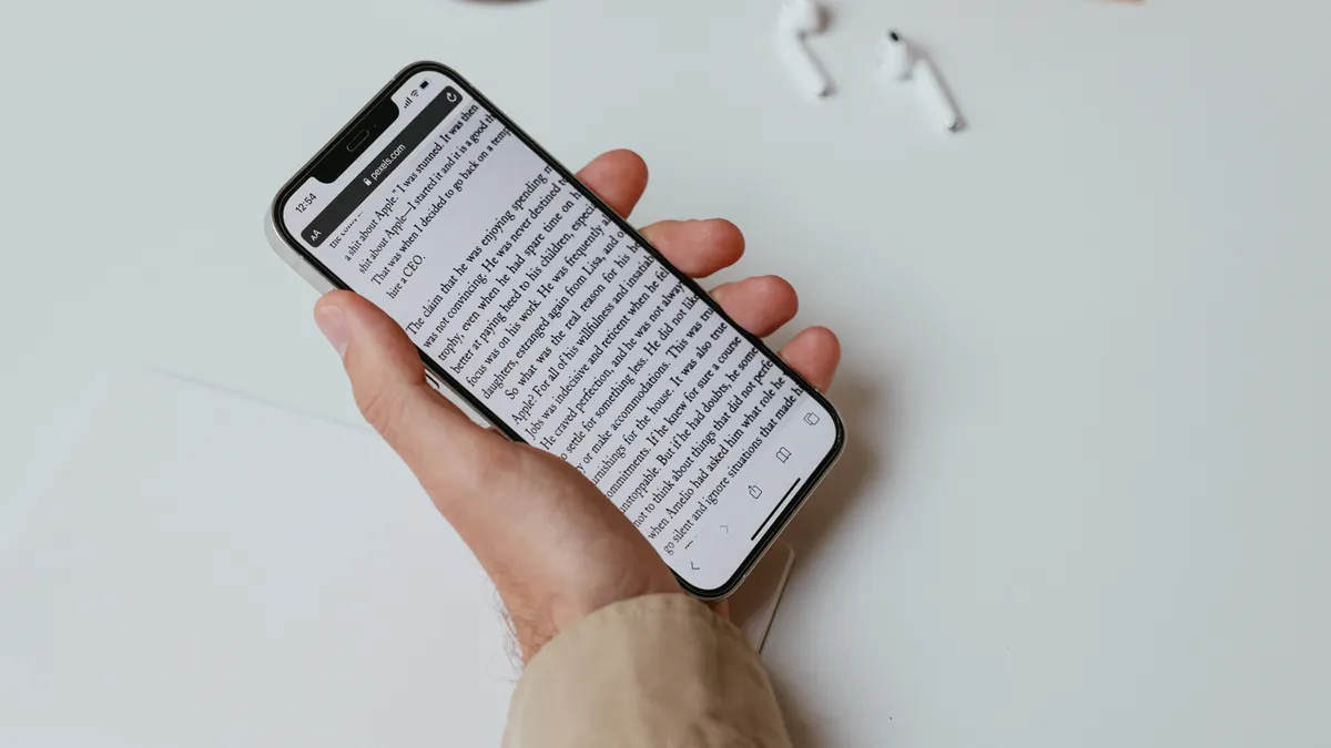 Compare AI content writing tools: features, output quality, and use cases — A Person Writing While Holding a Smartphone