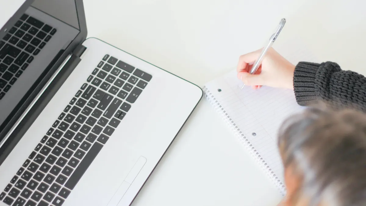 Top view of notebook planning beside a laptop
