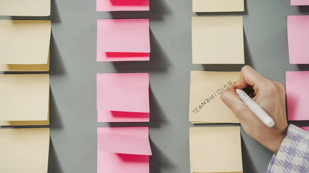 Content writing tools for teams: collaboration, versioning, and approval features compared — Person Writing on Yellow St