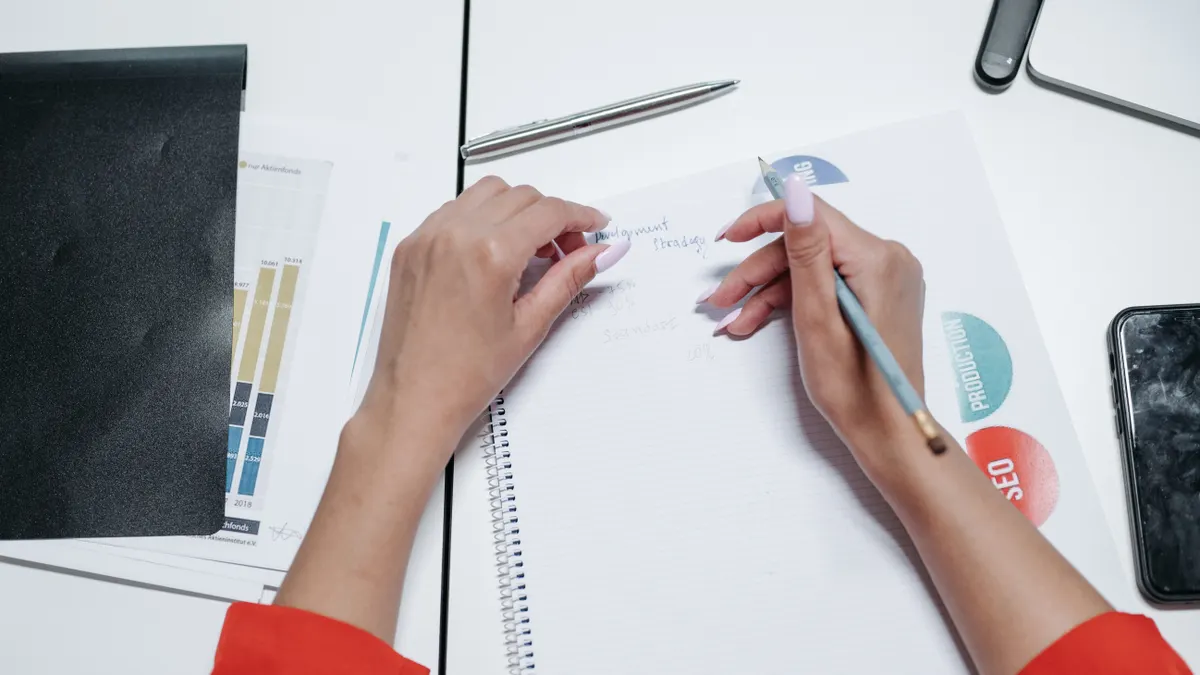 Content writing tools with built-in SEO features: which to pick for optimization — Person Writing on White Paper