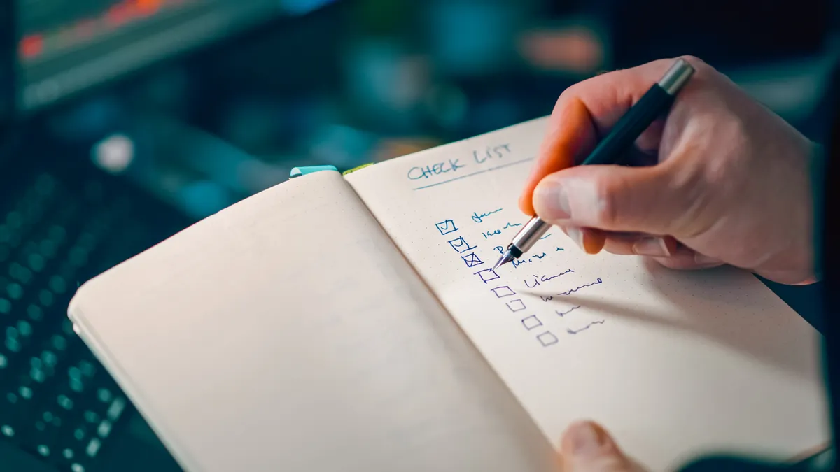 How to build an AI content review checklist Hand checking items in an open notebook checklist