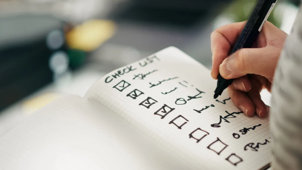 Using Content Writing Tools: Workflows & Evaluation — The Complete Guide — Close-up of a Hand Writing on a To-Do List